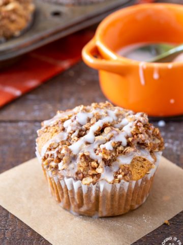 A pumpkin muffin sitting on a board