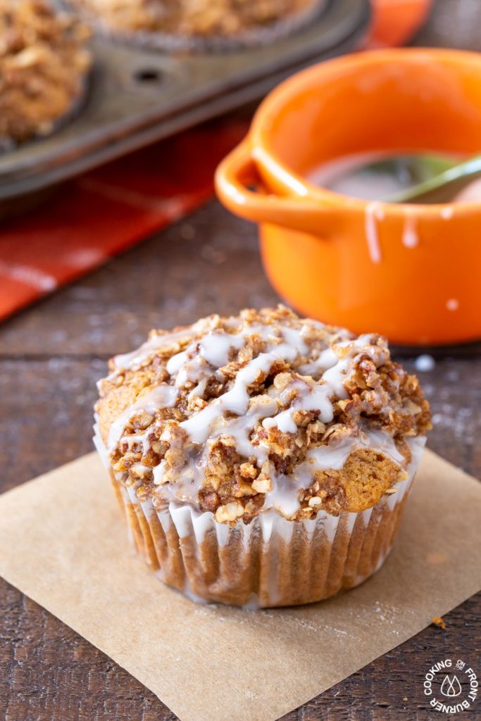 A pumpkin muffin sitting on a board