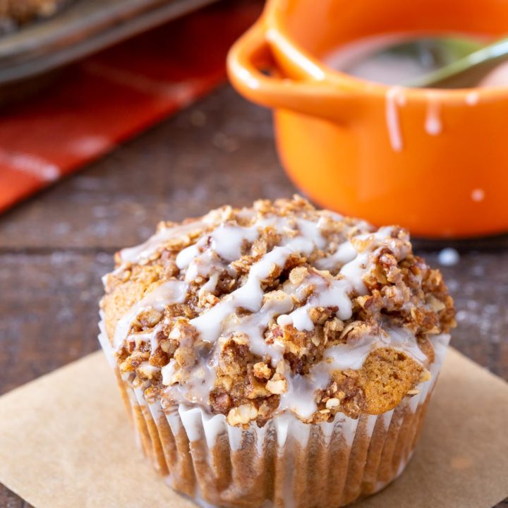 A pumpkin muffin sitting on a board