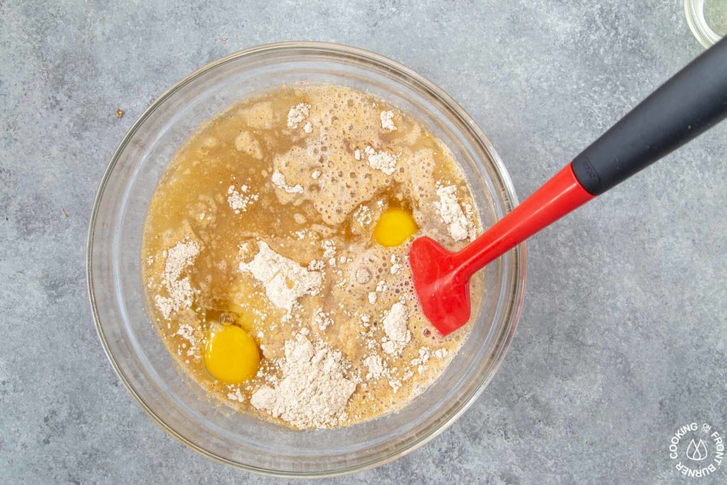 a person stirring ingredients needed for pumpkin muffins