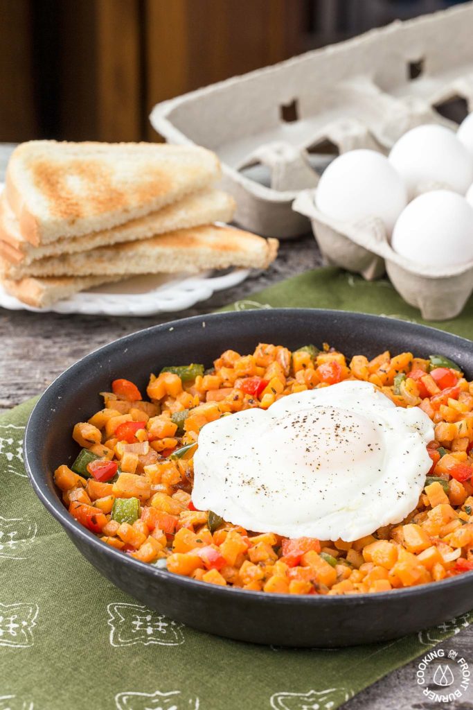 Sweet Potato Hash with egg in a skillet