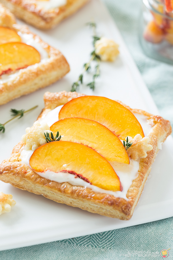 3 peach tarts on a white ceramic tray