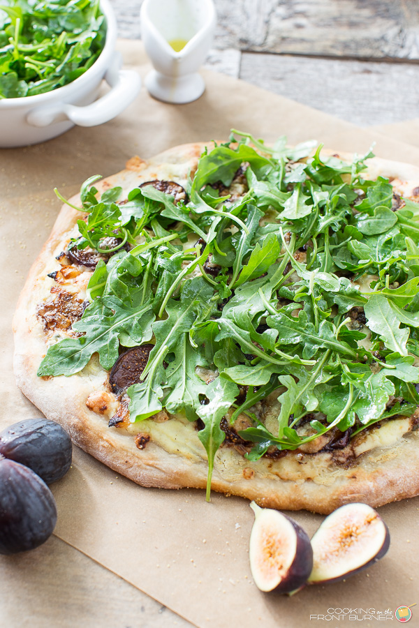 This Fresh Fig Pizza with Arugula recipe does not disappoint! It's a flavor explosion in your mouth with creamy ricotta with lemon, caramelized onions, gorgonzola, figs in reduced balsamic topped with peppery arugula! One slice or two! Fresh Fig Pizza with Arugula | Cooking on the Front Burner