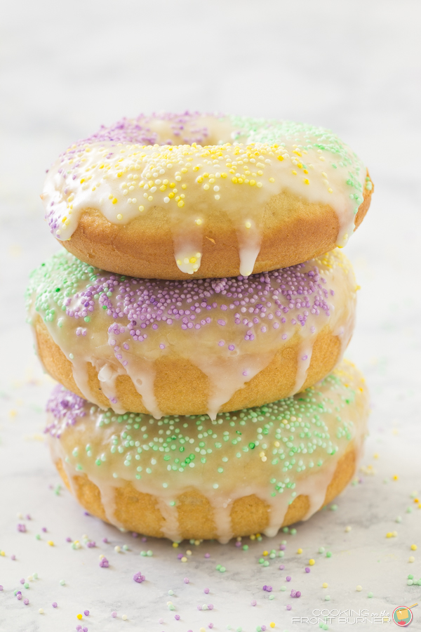 Perfect for Mardi Gras are these baked King Cake Donuts with a light glaze and fun sprinkles! Baked King Cake Donuts | Cooking on the Front Burner