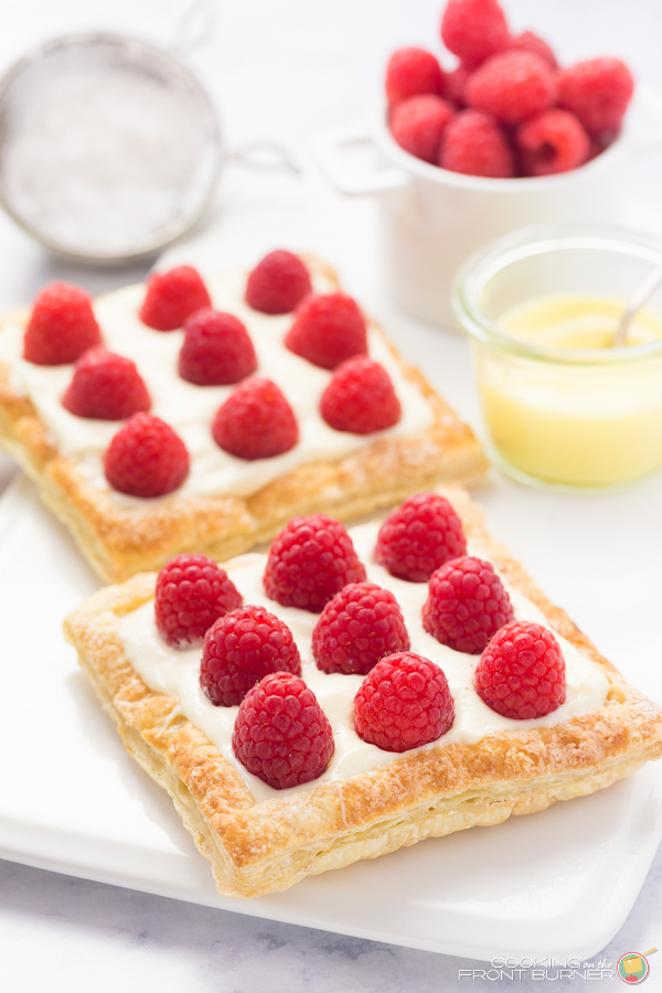 a lemon raspberry tart on a white plate