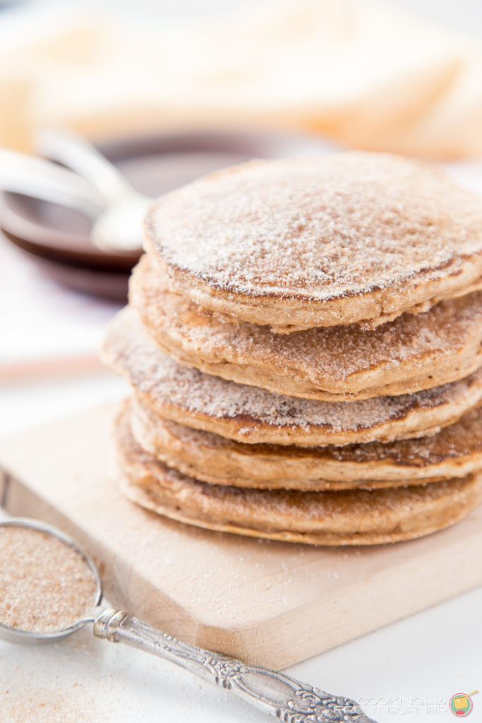 Churro Pancakes on a board with cinnamon sugar