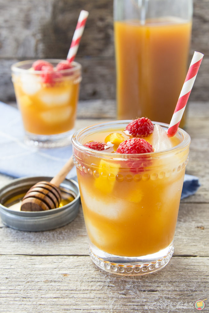 Raspberry mango iced tea is the perfect cold drink for summer! This iced tea recipe uses fresh raspberries and mango, giving the iced tea a burst of refreshing fruit flavor.