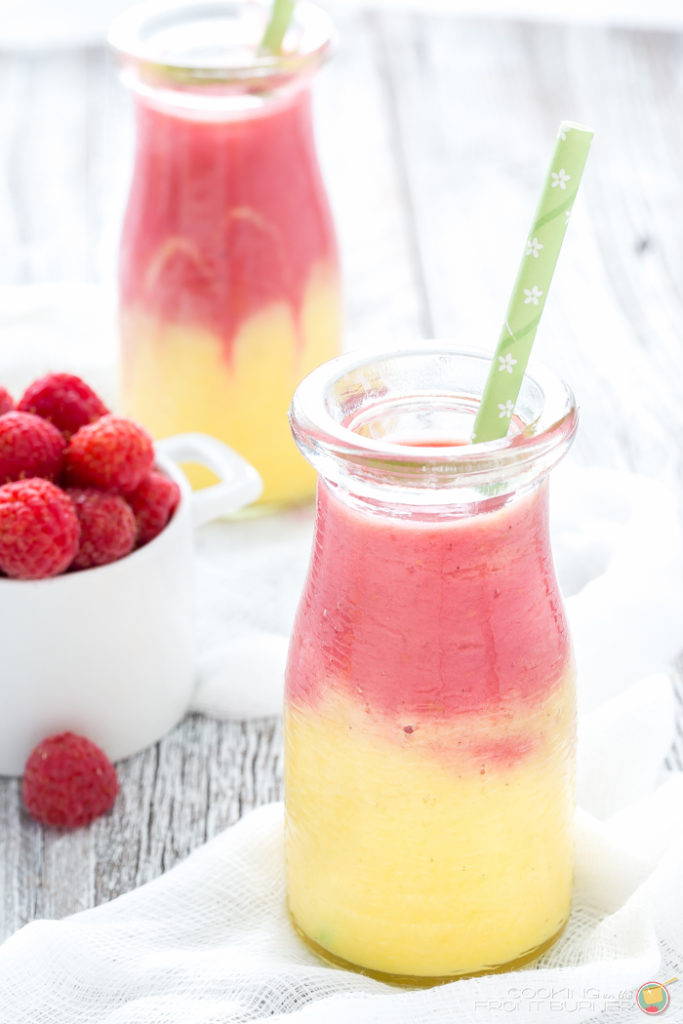 Start your day off right with this two toned Mango Raspberry Sunshine Yogurt Smoothie recipe. Easy to make and a healthy snack, too!