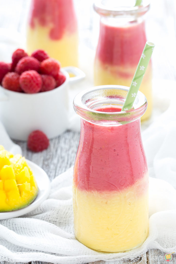 Start your day off right with this two toned Mango Raspberry Sunshine Yogurt Smoothie recipe. Easy to make and a healthy snack, too!