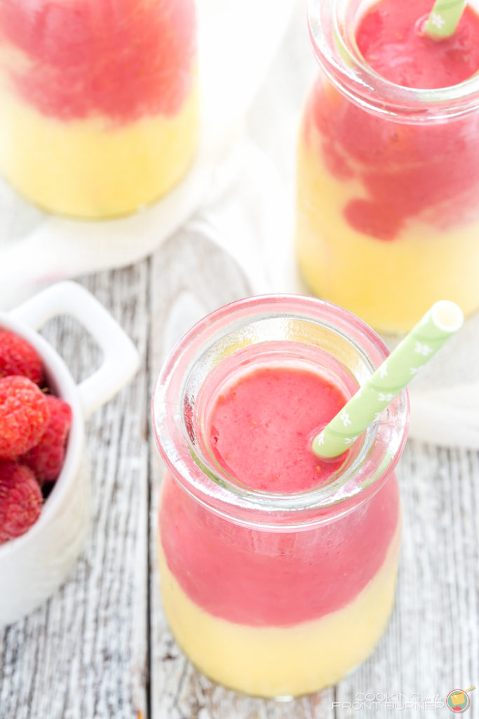 Start your day off right with this two toned Mango Raspberry Sunshine Yogurt Smoothie recipe. Easy to make and a healthy snack, too!