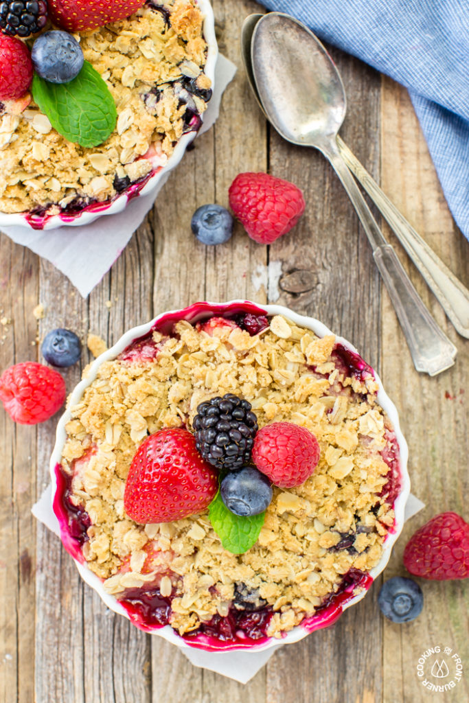 Get your berry crisp fix with these easy individual desserts that are full of raspberries, blackberries, blueberries and strawberries topped with a crunchy oatmeal topping.