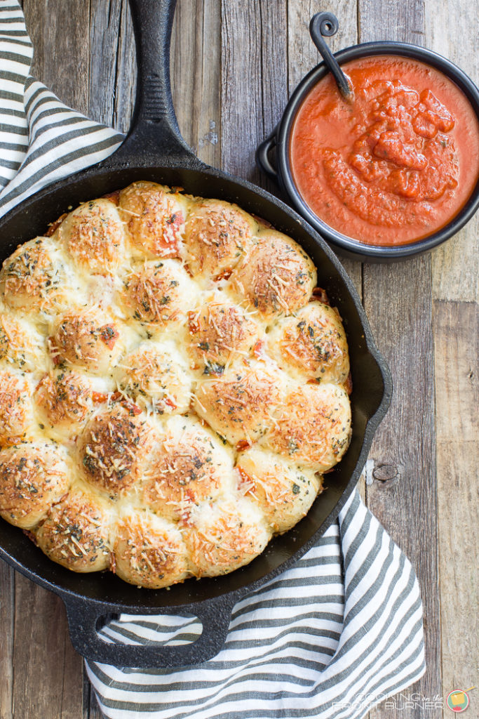 Pull apart pizza rolls make the perfect snack or dinner option. They are little, light, fluffy pillows topped with Italian seasonings, cheese and pepperoni tucked in between.