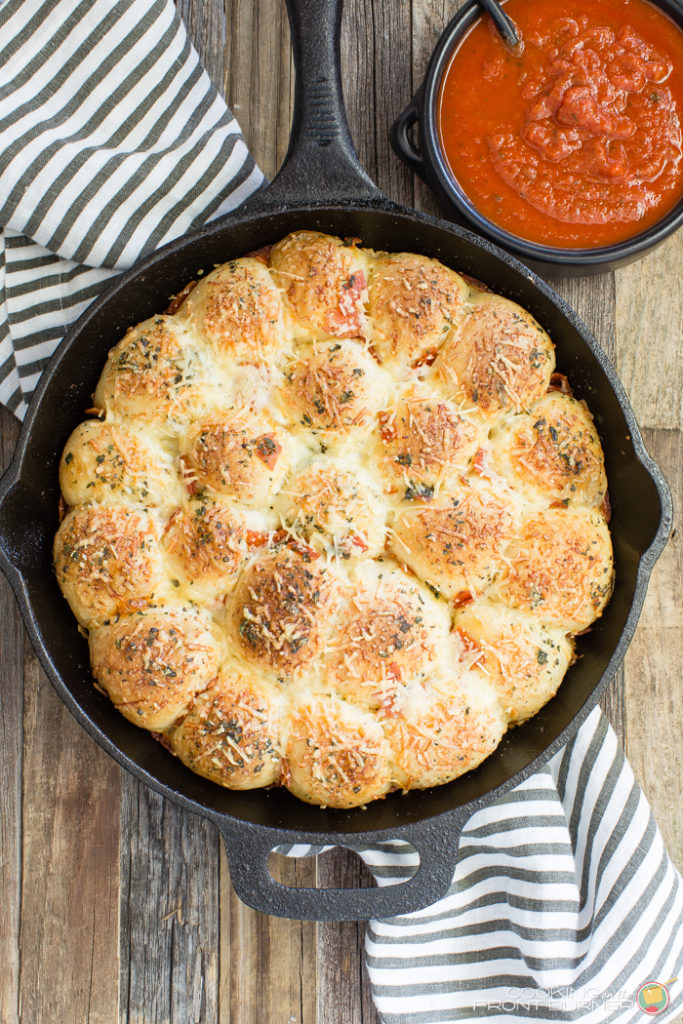 Pull apart pizza rolls make the perfect snack or dinner option. They are little, light, fluffy pillows topped with Italian seasonings, cheese and pepperoni tucked in between.