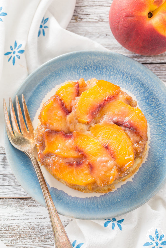 This individual upside down peach cake recipe is perfect for two with juicy peaches nestled in a creamy caramel topping and atop a light spongy cake. Mini Peach Upside-Down Cakes