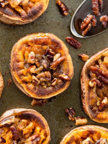 These Smashed Sweet Potatoes are the perfect side dish for any occasion.  The sweet potatoes are roasted with cinnamon, a bit of chili powder and topped with toasted maple pecans!