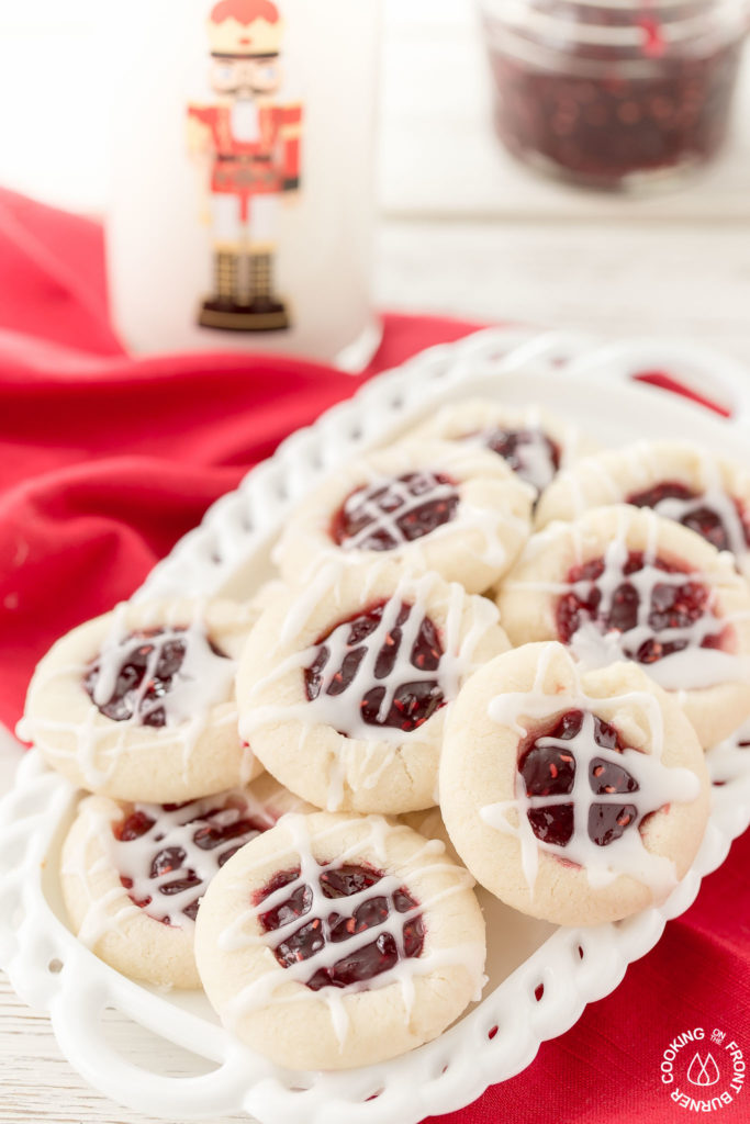 Your holiday cookie plate won't be complete unless you have these easy Raspberry Thumbprint Cookies with buttery shortbread, almond flavoring and glaze.  They look festive too! #christmascookies #shortbread