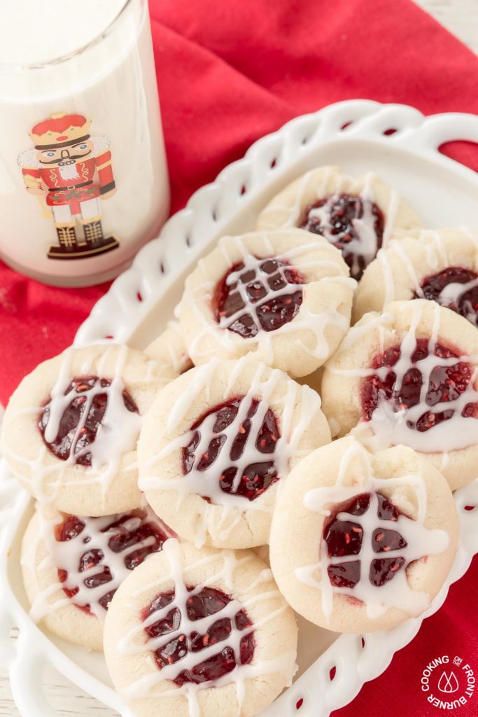 Your holiday cookie plate won't be complete unless you have these easy Raspberry Thumbprint Cookies with buttery shortbread, almond flavoring and glaze.  They look festive too! #christmascookies #shortbread