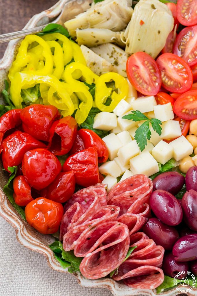 You will love this easy recipe for Italian Antipasto Salad that is loaded with veggies, meat, cheese and a lemon vinaigrette dressing. Make it big for a main course or smaller for side salads. #antipasto #italian #salad