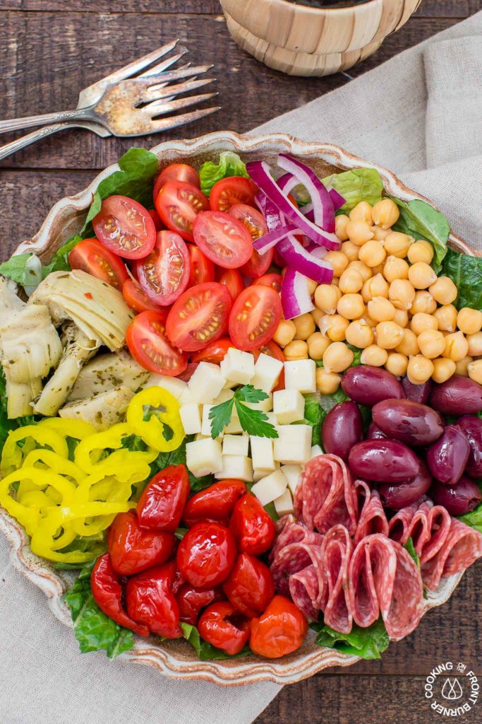 You will love this easy recipe for Italian Antipasto Salad that is loaded with veggies, meat, cheese and a lemon vinaigrette dressing. Make it big for a main course or smaller for side salads. #antipasto #italian #salad