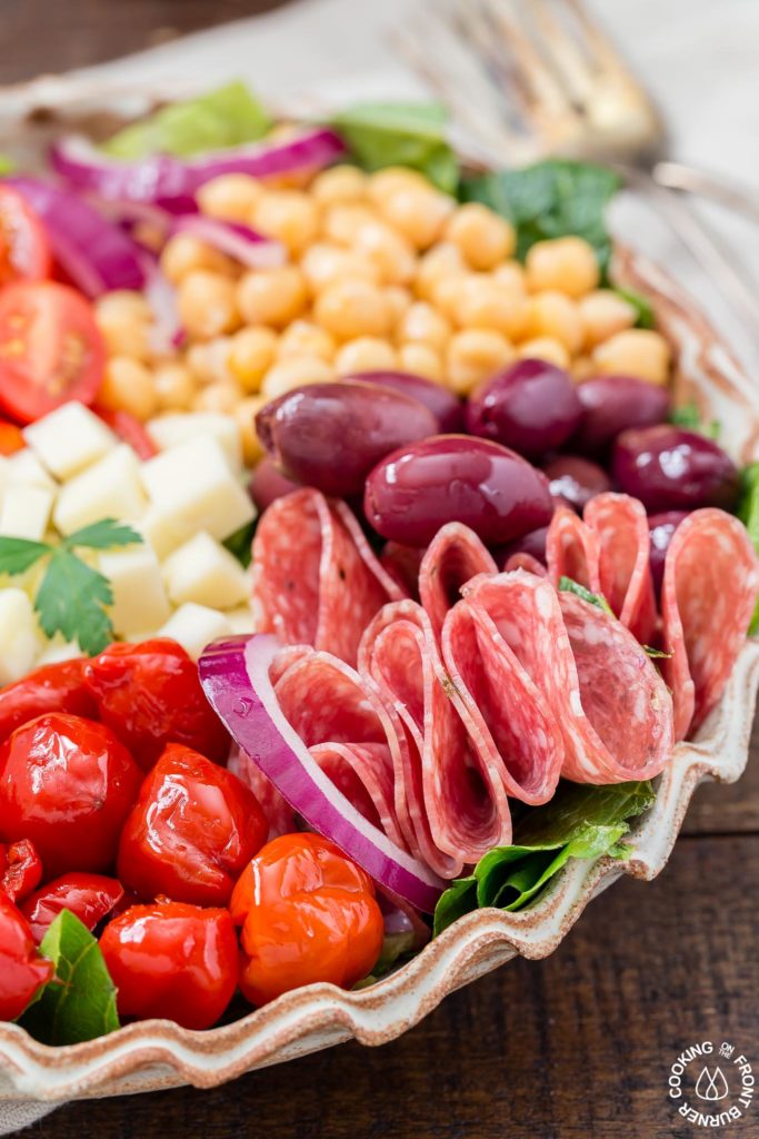 You will love this easy recipe for Italian Antipasto Salad that is loaded with veggies, meat, cheese and a lemon vinaigrette dressing. Make it big for a main course or smaller for side salads. #antipasto #italian #salad