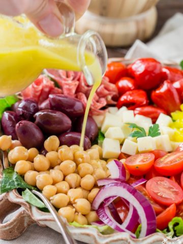 You will love this easy recipe for Italian Antipasto Salad that is loaded with veggies, meat, cheese and a lemon vinaigrette dressing. Make it big for a main course or smaller for side salads. #antipasto #italian #salad #lemonvinaigrette