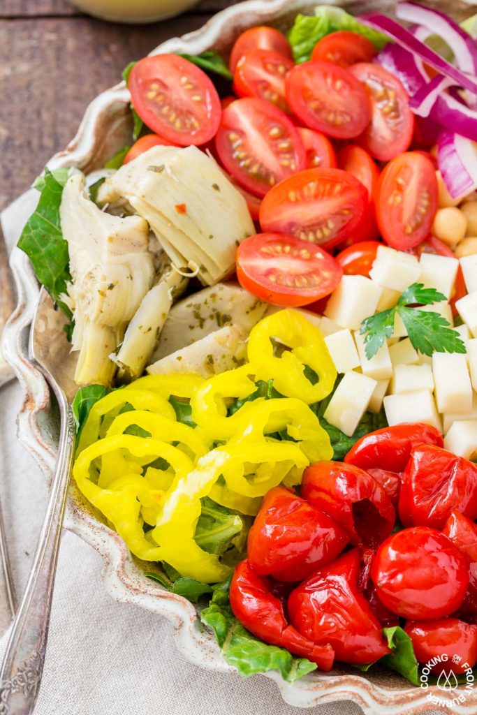 You will love this easy recipe for Italian Antipasto Salad that is loaded with veggies, meat, cheese and a lemon vinaigrette dressing. Make it big for a main course or smaller for side salads. #antipasto #italian #salad