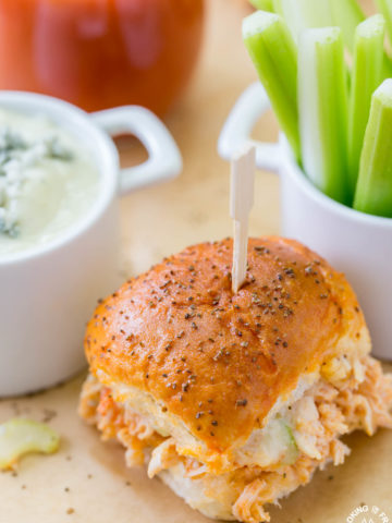 Your game day will be kicked up a notch with these Easy Buffalo Chicken Sliders!  The perfect party size sandwich with the right amount of spice, creamy blue cheese and some crunch celery.