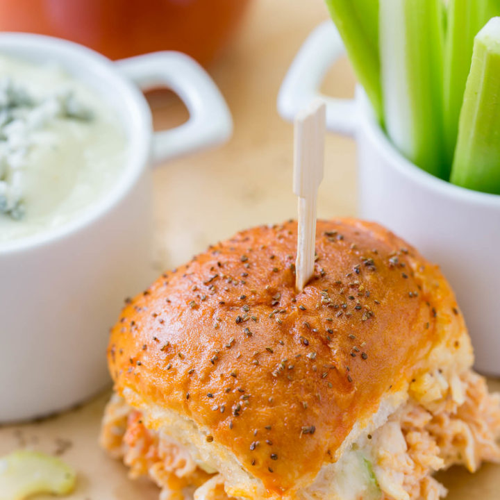 Your game day will be kicked up a notch with these Easy Buffalo Chicken Sliders!  The perfect party size sandwich with the right amount of spice, creamy blue cheese and some crunch celery.