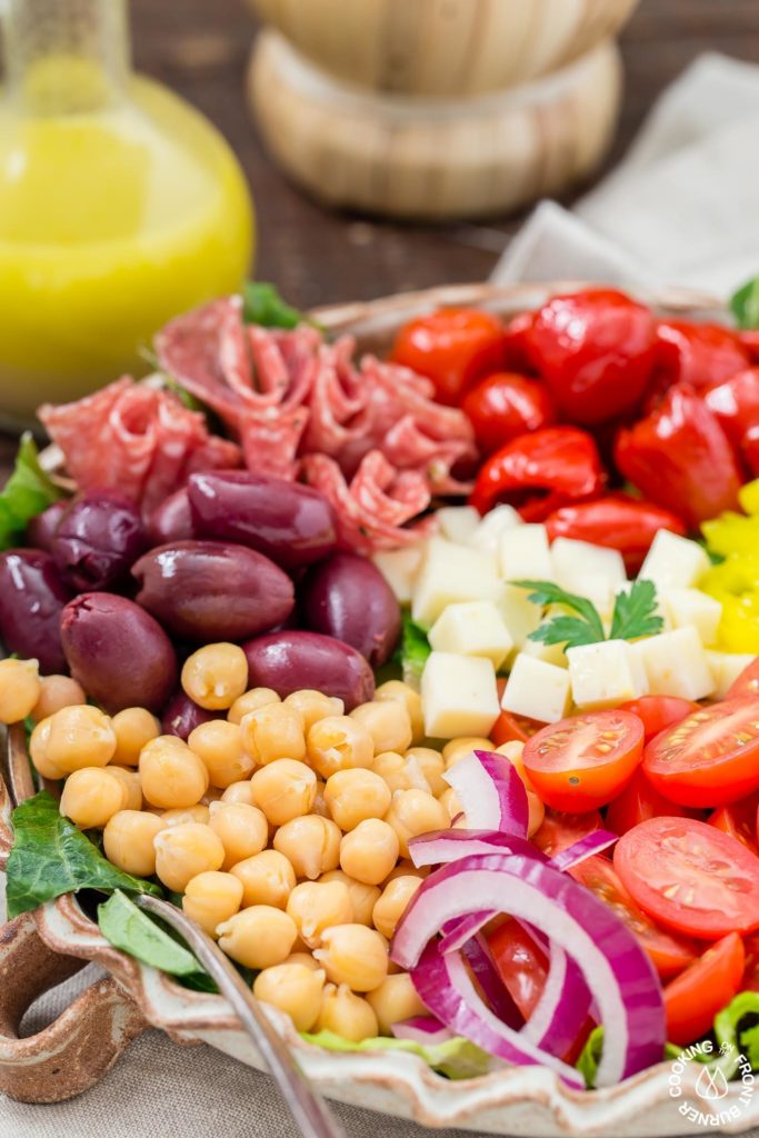You will love this easy recipe for Italian Antipasto Salad that is loaded with veggies, meat, cheese and a lemon vinaigrette dressing. Make it big for a main course or smaller for side salads. #antipasto #italian #salad