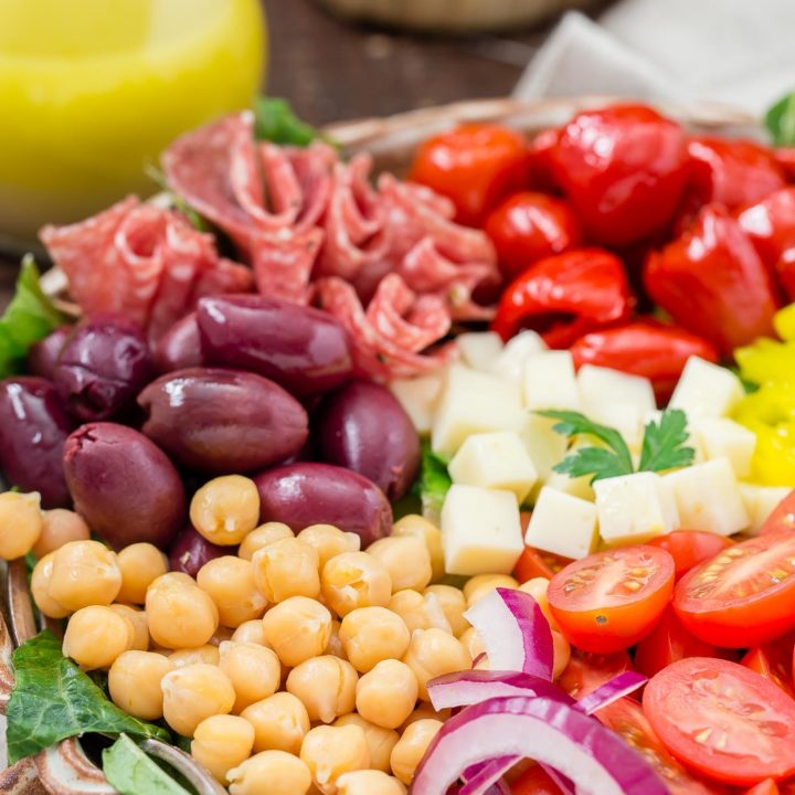 You will love this easy recipe for Italian Antipasto Salad that is loaded with veggies, meat, cheese and a lemon vinaigrette dressing. Make it big for a main course or smaller for side salads. #antipasto #italian #salad