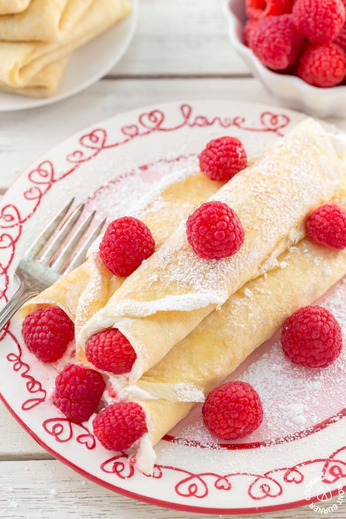 These Raspberry Vanilla Cream Crepes make the perfect dessert for Valentine's Day or any time you want to impress that someone special.  The crepes have a creamy vanilla filling and the fresh raspberries add a pop of color.