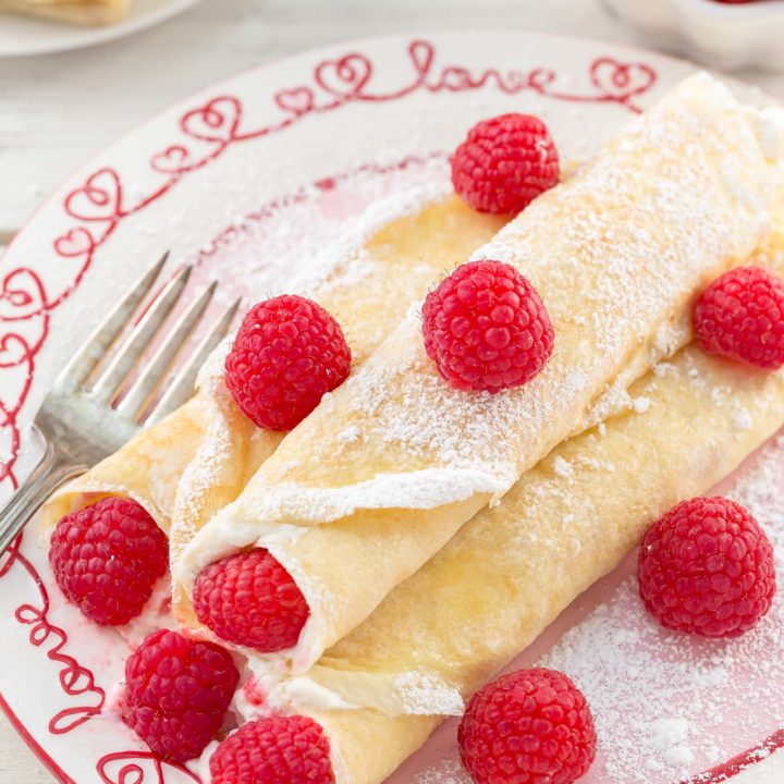These Raspberry Vanilla Cream Crepes make the perfect dessert for Valentine's Day or any time you want to impress that someone special.  The crepes have a creamy vanilla filling and the fresh raspberries add a pop of color.