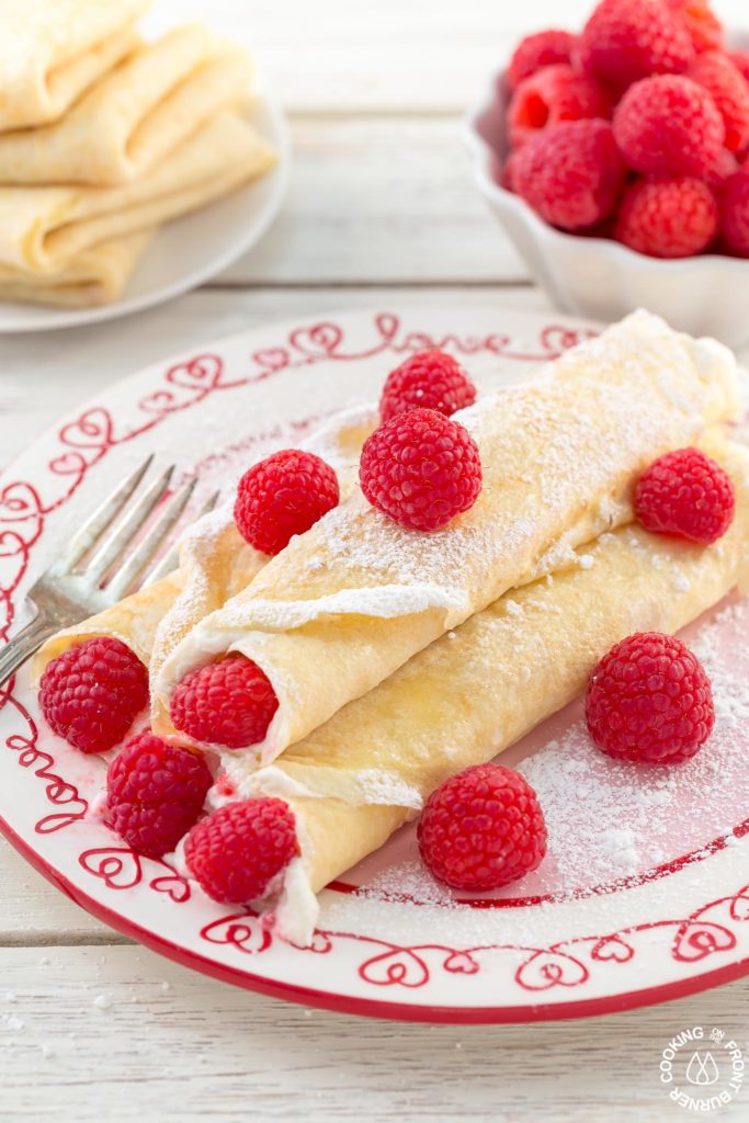 These Raspberry Vanilla Cream Crepes make the perfect dessert for Valentine's Day or any time you want to impress that someone special.  The crepes have a creamy vanilla filling and the fresh raspberries add a pop of color.