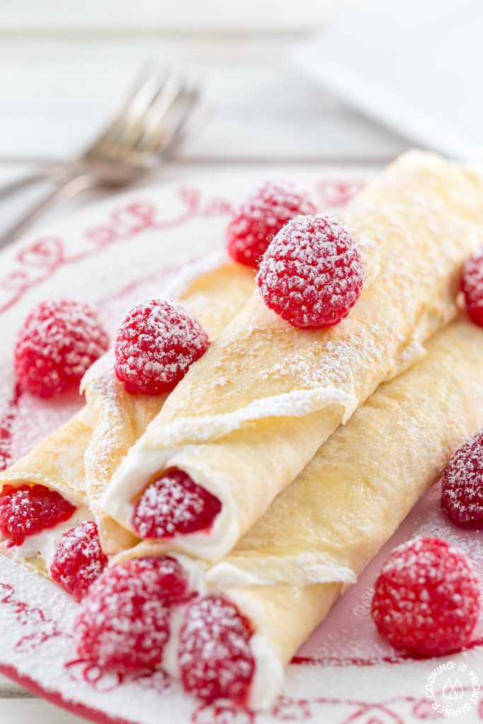 These Raspberry Vanilla Cream Crepes make the perfect dessert for Valentine's Day or any time you want to impress that someone special.  The crepes have a creamy vanilla filling and the fresh raspberries add a pop of color.