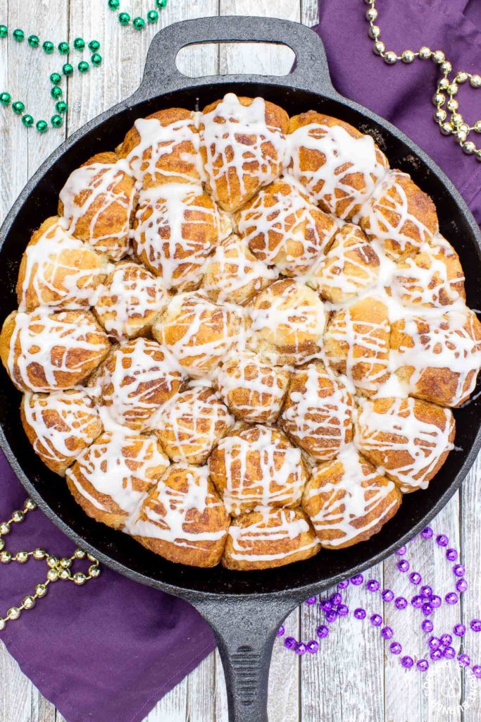 Your taste buds will be tantalized with these Skillet Cinnamon Rolls.  They are easy to make by starting with frozen rolls, the right amount of cinnamon and sugar and drizzled with a vanilla glaze.  Your kitchen will smell amazing too while they are baking!