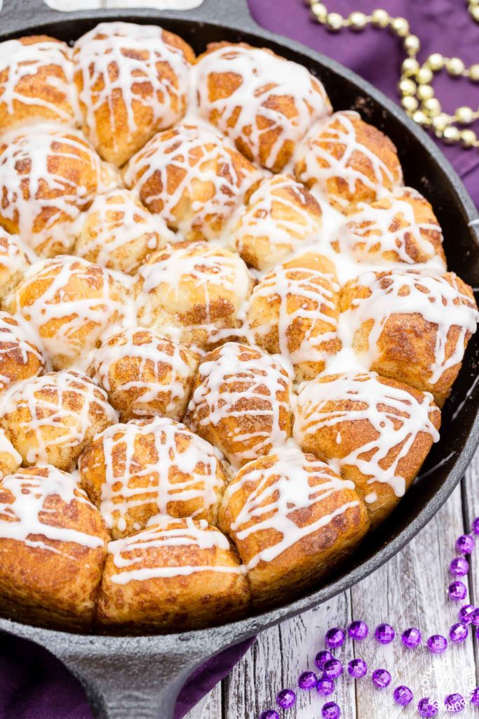 Your taste buds will be tantalized with these Skillet Cinnamon Rolls.  They are easy to make by starting with frozen rolls, the right amount of cinnamon and sugar and drizzled with a vanilla glaze.  Your kitchen will smell amazing too while they are baking! #breakfast #skilletrolls #cinnamon rolls