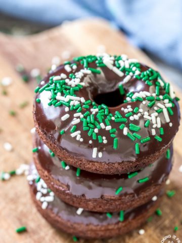 These chocolate Irish Cream Glazed Donuts are baked - not fried - and have a thick layer of chocolate ganache and festive sprinkles.  They are so easy to make and are perfect for breakfast for a sweet treat!