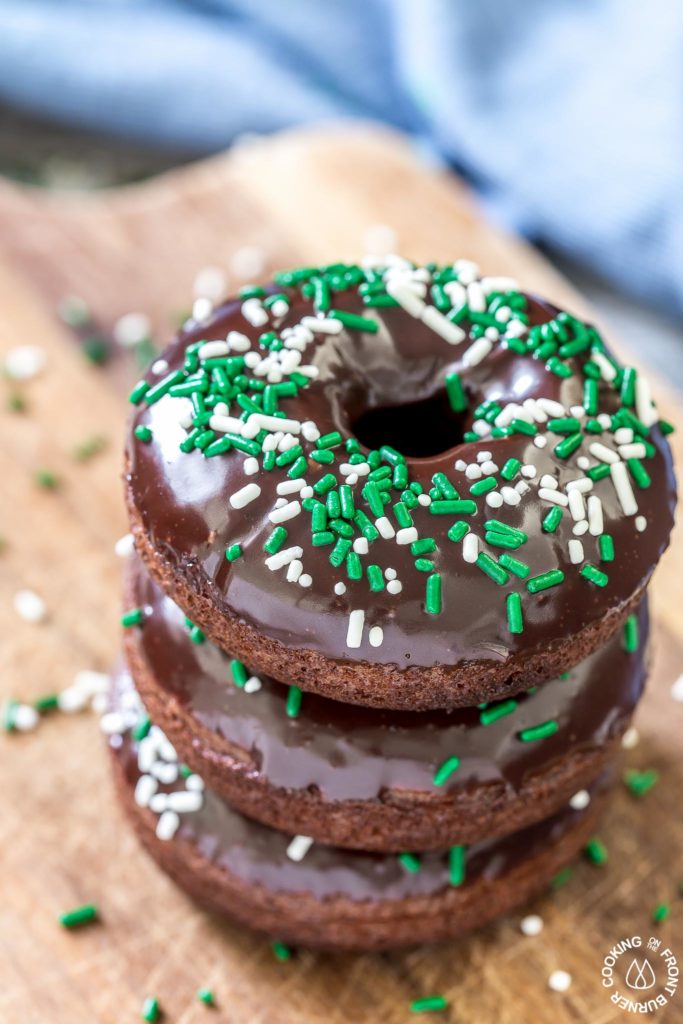 These chocolate Irish Cream Glazed Donuts are baked - not fried - and have a thick layer of chocolate ganache and festive sprinkles.  They are so easy to make and are perfect for breakfast for a sweet treat!