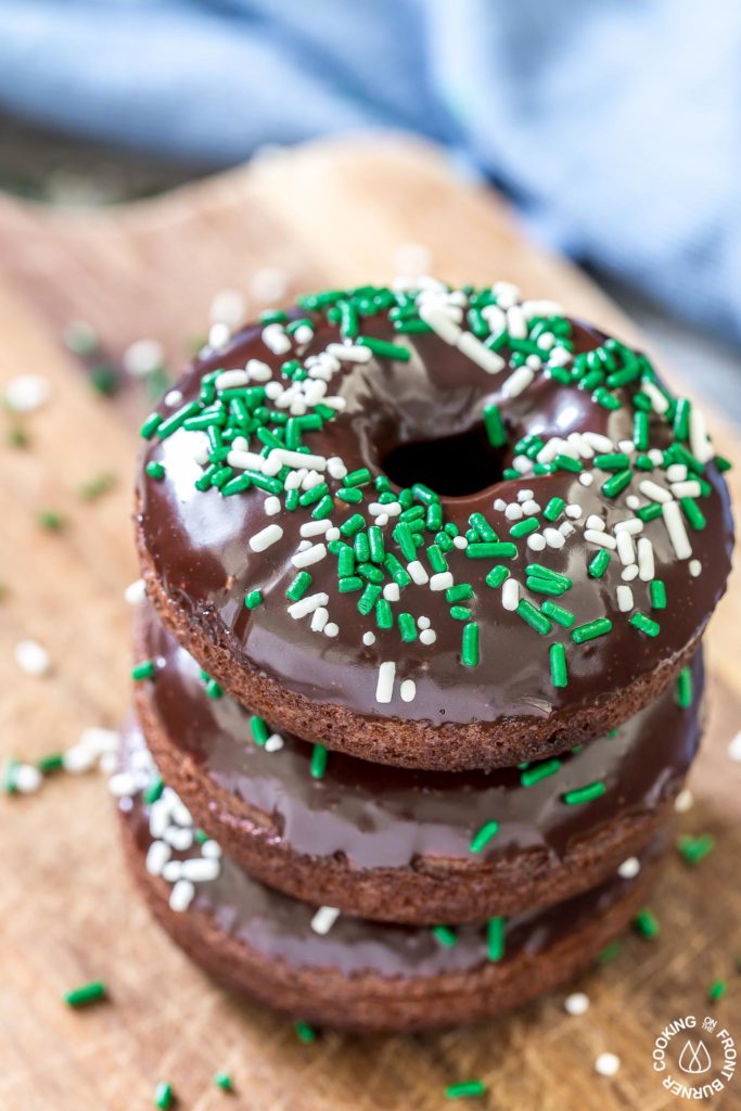 These chocolate Irish Cream Glazed Donuts are baked - not fried - and have a thick layer of chocolate ganache and festive sprinkles.  They are so easy to make and are perfect for breakfast for a sweet treat!