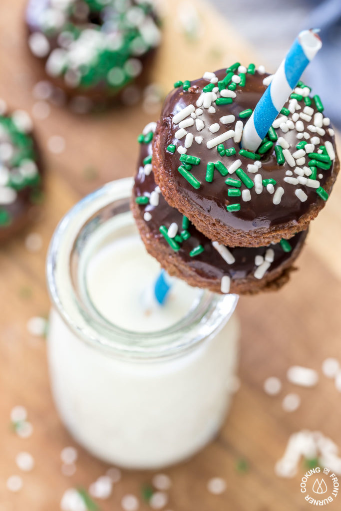 These chocolate Irish Cream Glazed Donuts are baked - not fried - and have a thick layer of chocolate ganache and festive sprinkles.  They are so easy to make and are perfect for breakfast for a sweet treat! #donuts #chocolate #ganache #irishcream #baked