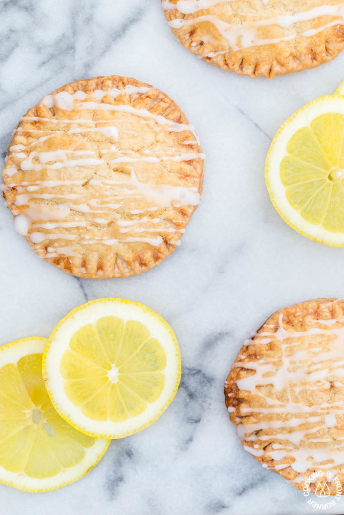 Don't these Lemon Curd Hand Pies look cute and fun to eat?  You will love the flaky crust, tangy lemon curd filling drizzled with a powdered sugar glaze.  The best part is they can be ready in under 30 minutes with 4 ingredients! #lemoncurd #handpies #dessert