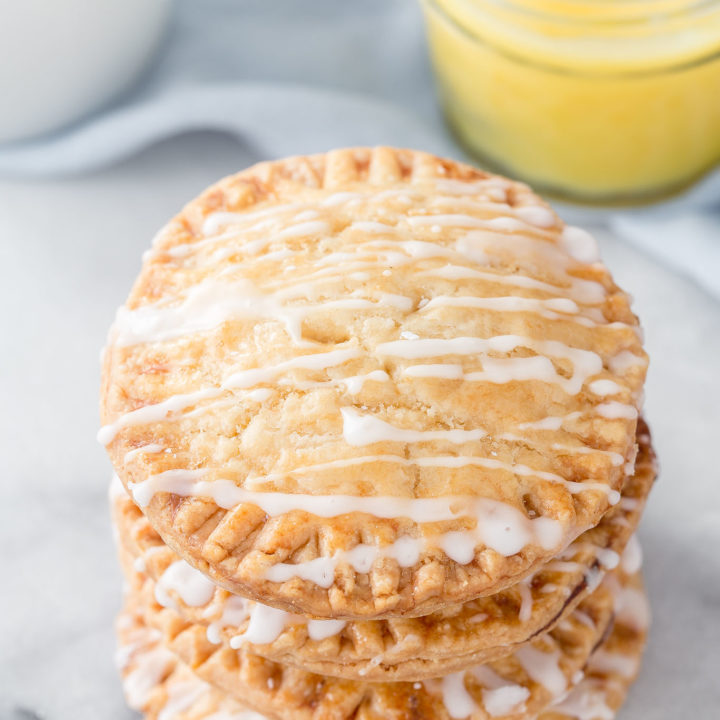 Don't these Lemon Curd Hand Pies look cute and fun to eat?  You will love the flaky crust, tangy lemon curd filling drizzled with a powdered sugar glaze.  The best part is they can be ready in under 30 minutes with 4 ingredients! #lemoncurd #handpies #dessert