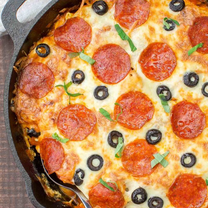 In 30 minutes you can serve this Pizza Tortellini Skillet Casserole on the family table.  Talk about freaky fast and delicious!  It's a very comforting dish with tender cheese pasta, a rich marinara sauce, pepperoni, olives and two kinds of cheeses and all baked in one skillet!   #skillet #pasta #casserole