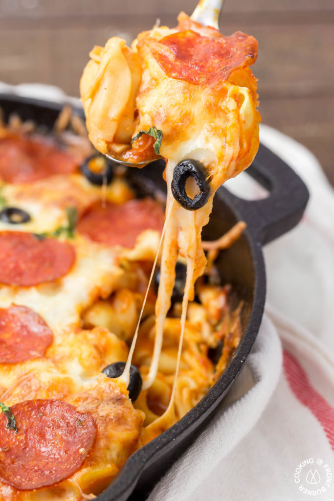 In 30 minutes you can serve this Pizza Tortellini Skillet Casserole on the family table.  Talk about freaky fast and delicious!  It's a very comforting dish with tender cheese pasta, a rich marinara sauce, pepperoni, olives and two kinds of cheeses and all baked in one skillet!   #skillet #pasta #casserole #30minute