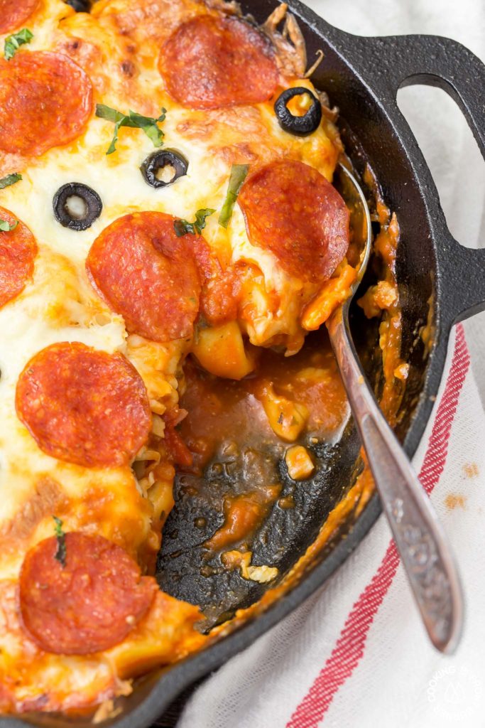 In 30 minutes you can serve this Pizza Tortellini Skillet Casserole on the family table.  Talk about freaky fast and delicious!  It's a very comforting dish with tender cheese pasta, a rich marinara sauce, pepperoni, olives and two kinds of cheeses and all baked in one skillet!   #skillet #pasta #casserole #30minute