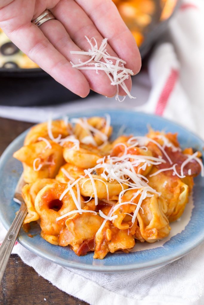 In 30 minutes you can serve this Pizza Tortellini Skillet Casserole on the family table.  Talk about freaky fast and delicious!  It's a very comforting dish with tender cheese pasta, a rich marinara sauce, pepperoni, olives and two kinds of cheeses and all baked in one skillet!   #skillet #pasta #casserole #30minute