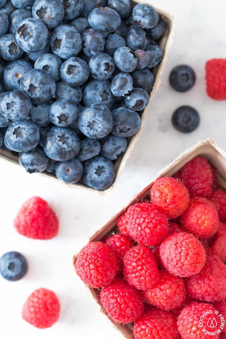 fresh blueberries and raspberries in containers