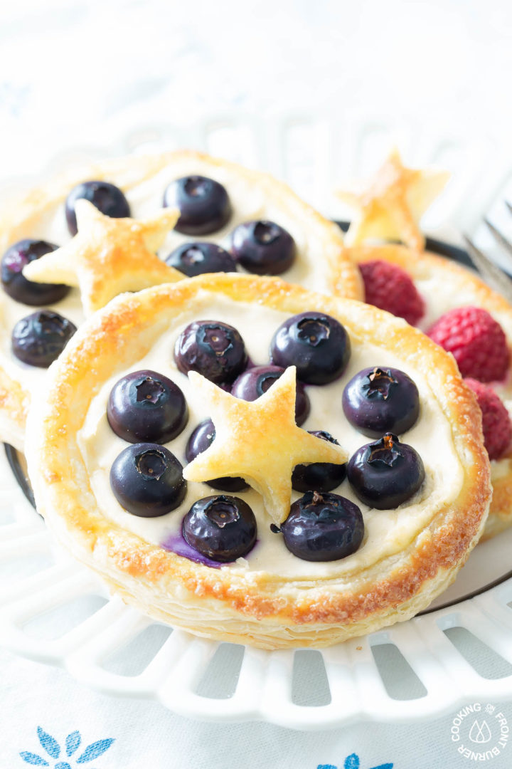 fruit pastries on a white plate with a fork