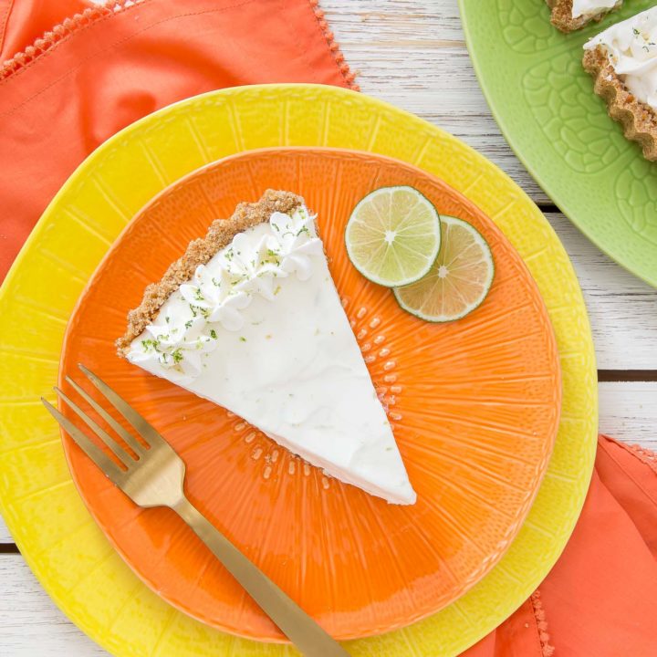 Light and refreshing describes this no-bake Frozen Margarita Tart.  You will love the creamy whipped texture with fresh lime juice, lime zest, triple sec, tequila mixture all piled into a salty pretzel crust.  