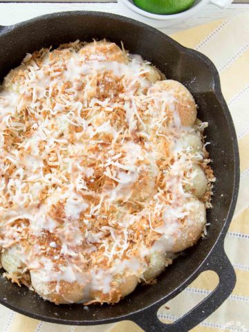 These Lime Coconut Skillet Rolls are a perfect way to celebrate spring.  The light and fluffy rolls are topped with lime zest, sweet coconut and drizzled with a lime glaze.